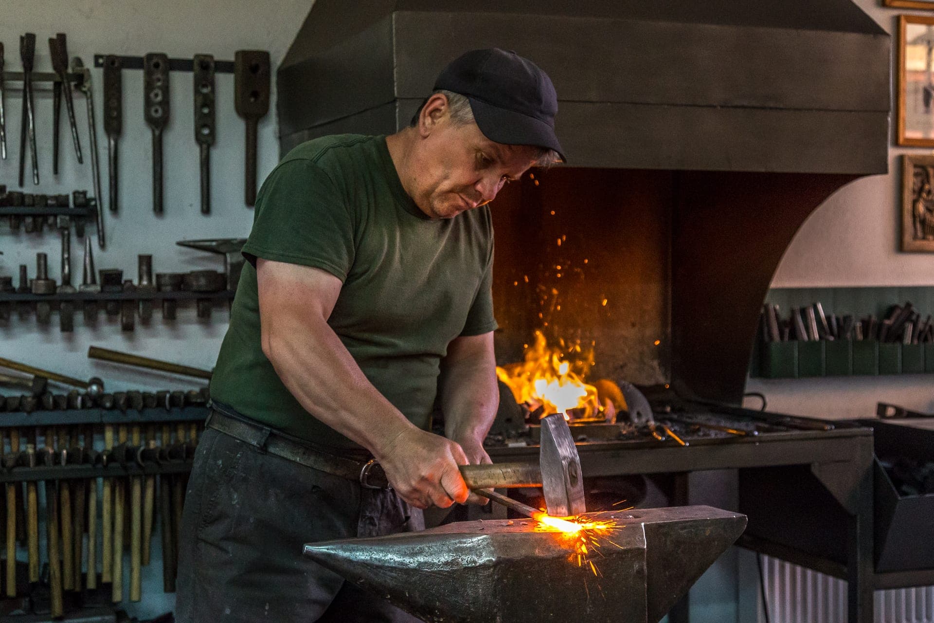 Local blacksmith at work, sparks flying from glowing metal