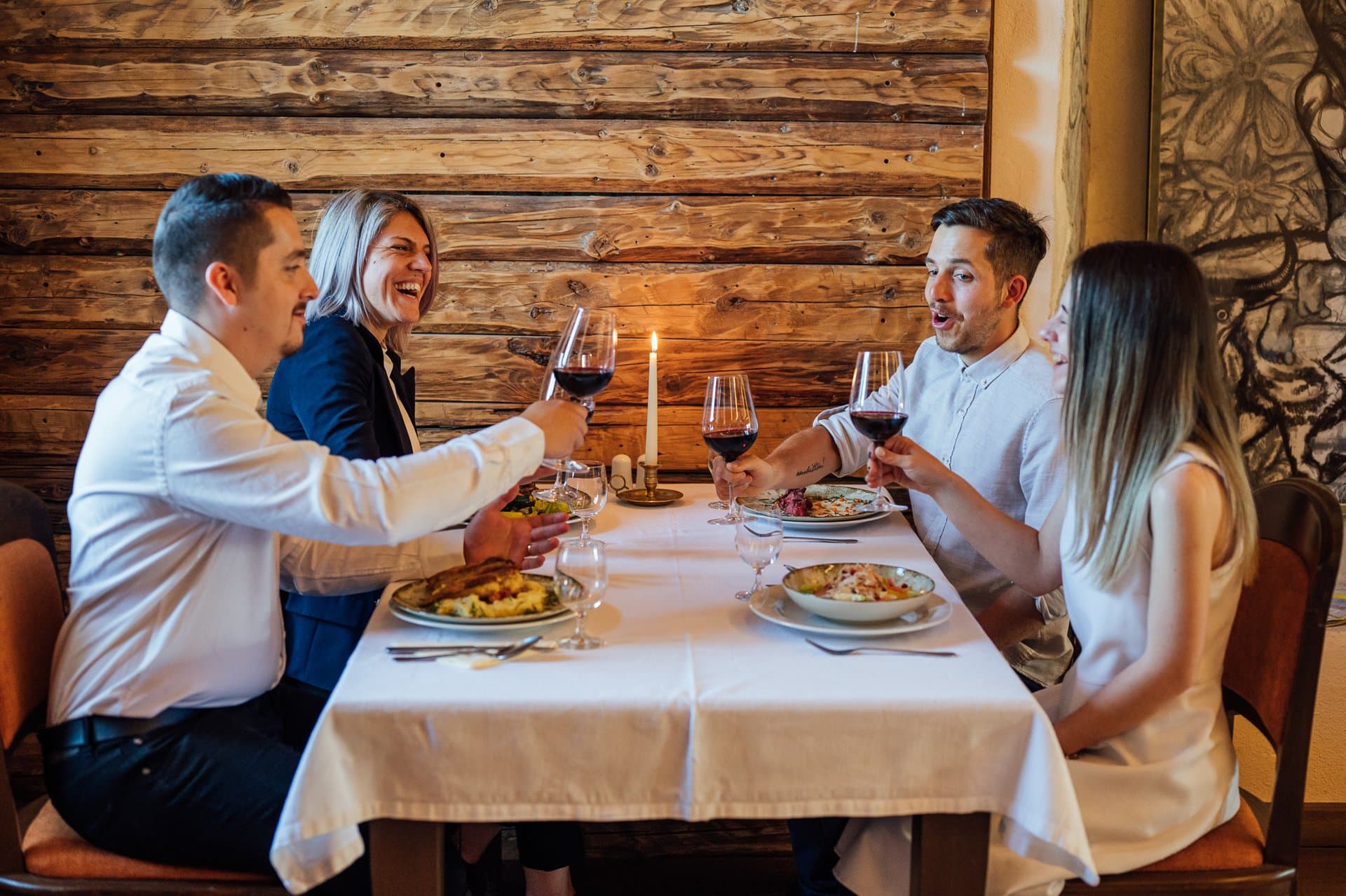 Friends toasting with red wine at dinner