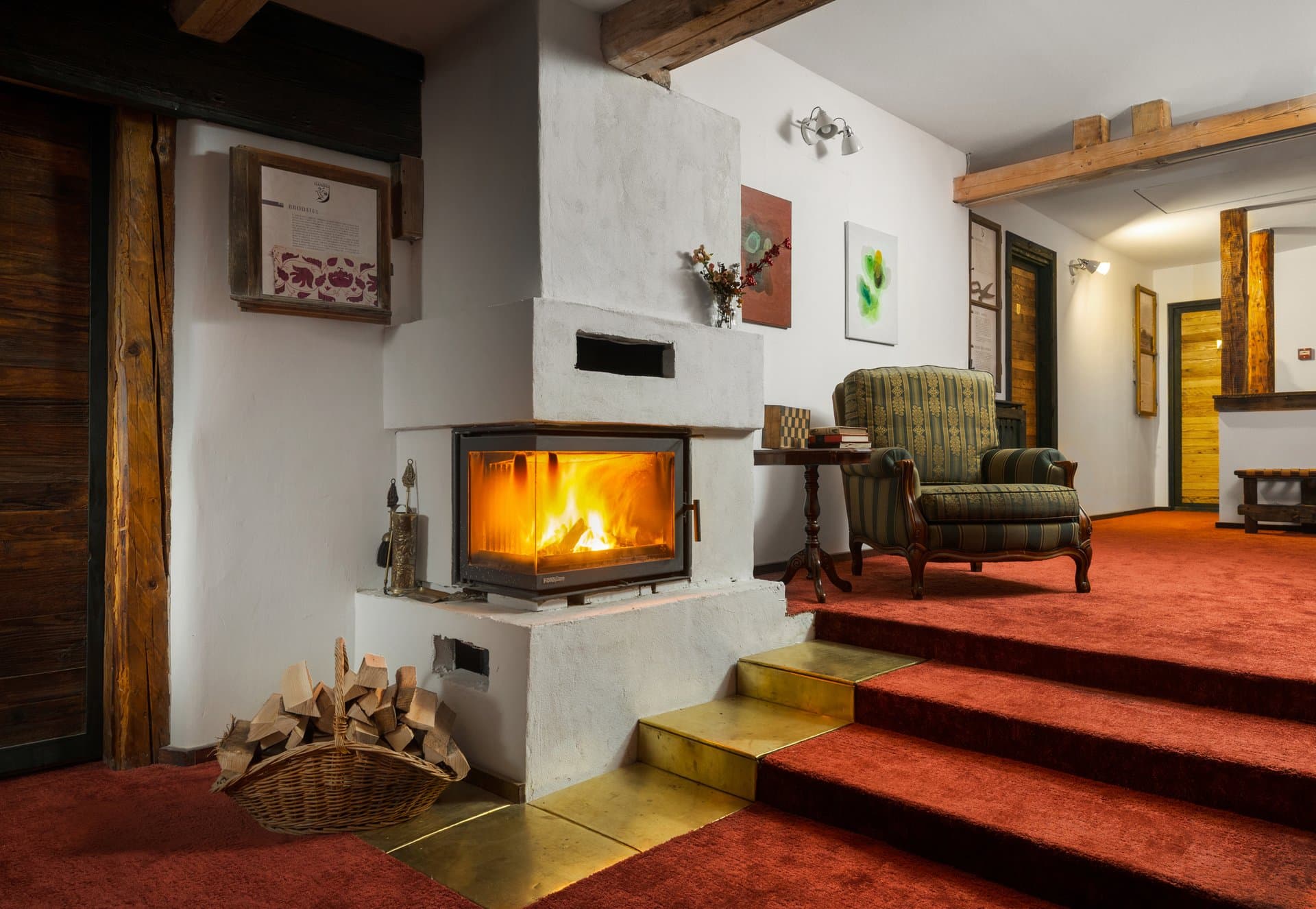 The Crafts House interior with traditional fireplace, wooden beams, and cozy atmosphere
