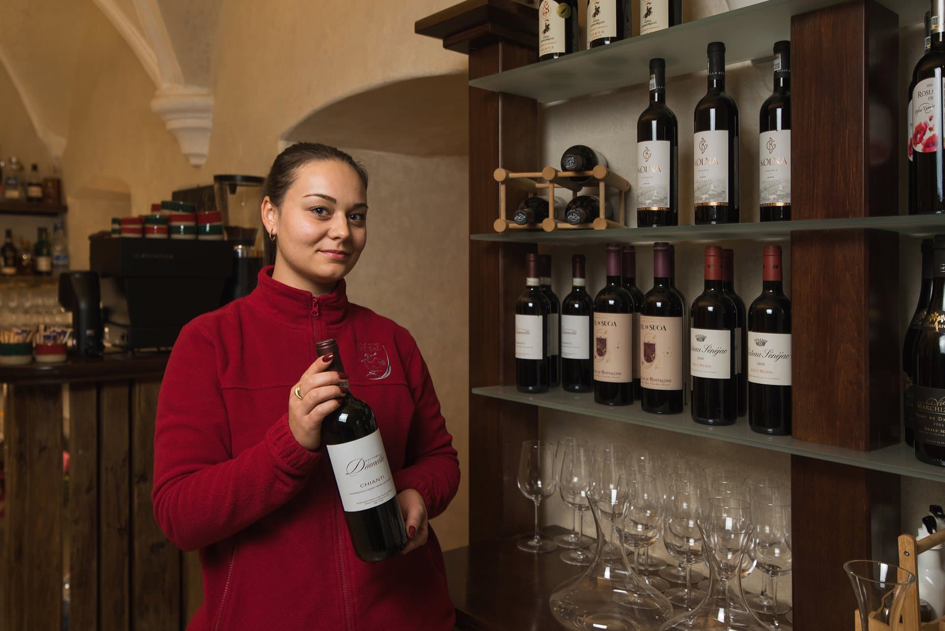 Restaurant and Service Team member presenting a bottle of wine from the castle's collection