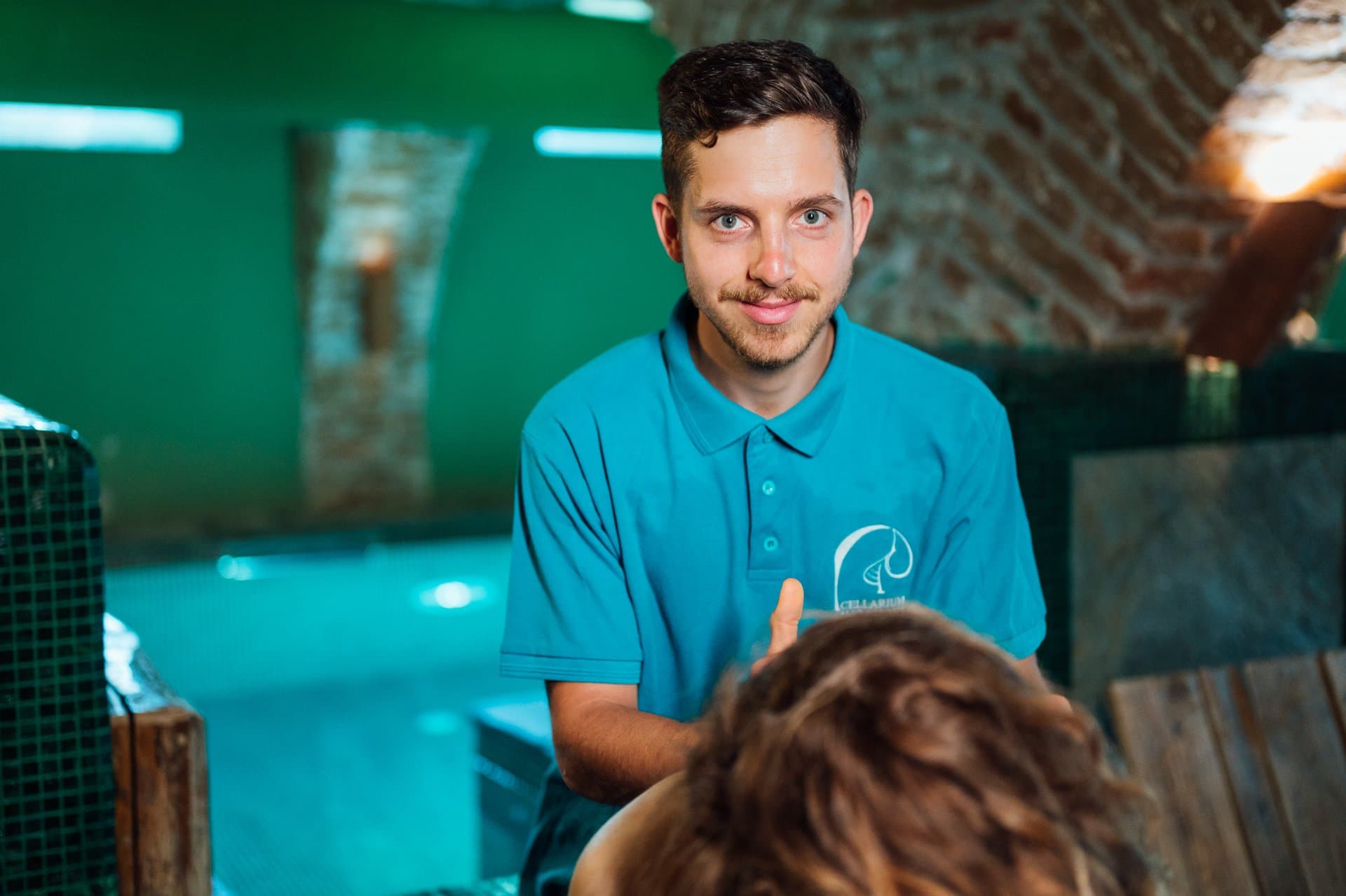 Spa Team member holding teal towels in the Tepidarium at the Cellarium Slow Down Spa